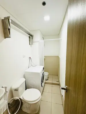 a bathroom with a toilet and a sink at Starlight Suites in Trece Martires
