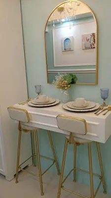 a dressing table with a mirror and a table with chairs at Homefort at Shore Residences in Manila
