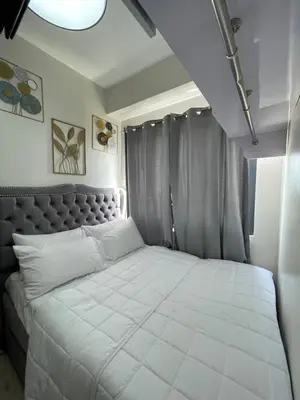 a bedroom with a large white bed with curtains at Hope Serenity, Spring Residences Tower 3 in Manila