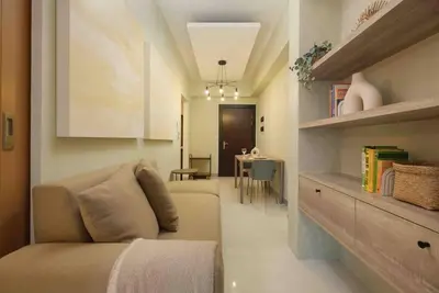 a living room with a couch and a table at 1 BR with balcony in Uptown BGC in Manila