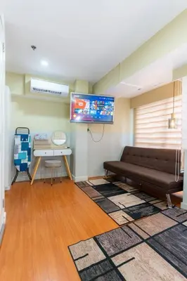 a living room with a couch and a table at A2J BGC Luxury 2BR Loft Near High Street, Airport in Manila