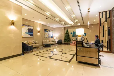 a lobby with a person sitting at a desk in a hotel at Luxury Condo at Venice Mall near Airport, BGC & Makati in Manila