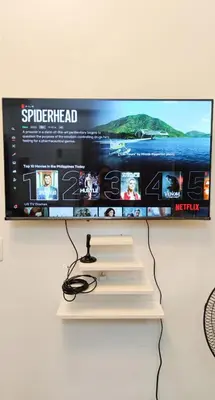 a flat screen tv hanging on a wall at Anuva Stays in Manila
