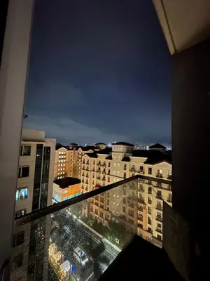 a view of a city at night from a balcony at Condo 1 Palm Tree Across NAIA T3 in Manila