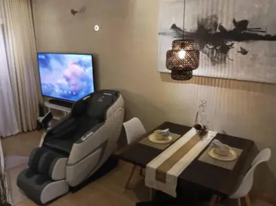 a living room with a table and a television at WHT Pod in Punta