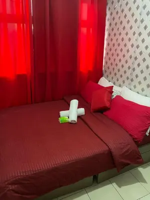 a bed with a teddy bear sitting on top of it at Pierrecondotel in Manila