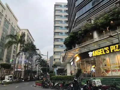a building with motorcycles parked in front of it at A&G Condotel at 101 Newport Across NAIA T3 in Manila