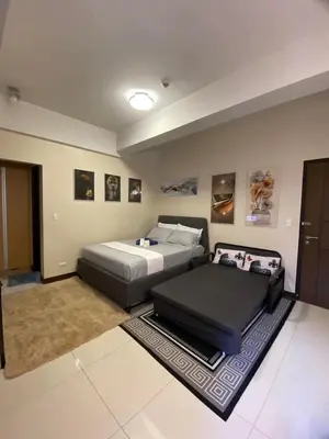 a bedroom with two beds in a room at A&G Condotel at 101 Newport Across NAIA T3 in Manila