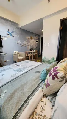 a large bed in a room with a wall at Le Palis Suite in Bukal