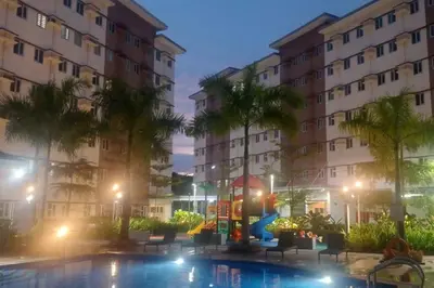 a swimming pool in front of two buildings at night at Happy Stays C - 300mbps - 65