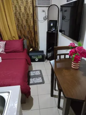 a living room with a couch and a table at Nicecondotel in Manila