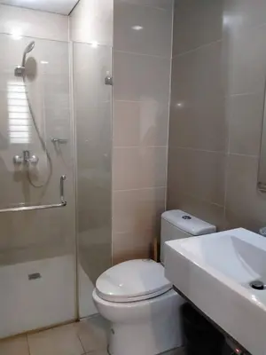 a bathroom with a toilet and a shower and a sink at RG condotel Near Naia Terminal 3 in Manila