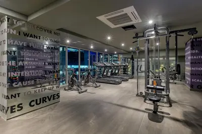 a gym with several treadmills and bikes in a room at Cozy High Ceiling Studio @ Ortigas near Podium, Megamall in Manila