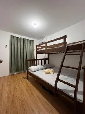 a bedroom with two bunk beds and a wooden floor at Modern Home and Stylish Design in Ibaba