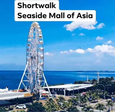 a large ferris wheel in a seaside mall of asahi at Shore Residence D21 shortwalk MOA Balconypoolview in Manila