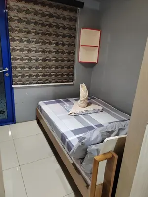 a small bed in a room with a window at Sea Residences-Reisha in Manila