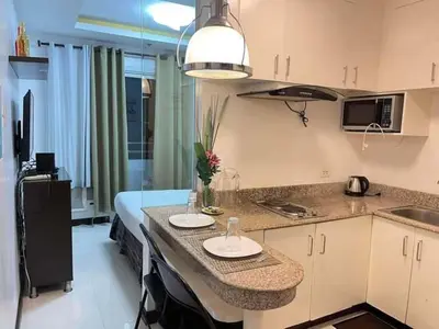 a kitchen with a counter with two plates on it at Birchtower studio in Manila