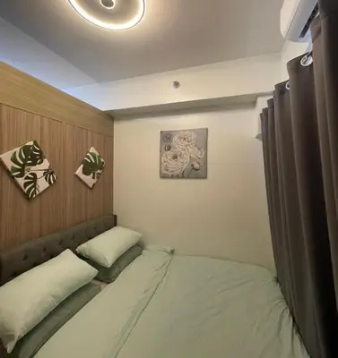 a small bedroom with a bed in the corner at MOA Staycation at Shore 2 in Manila