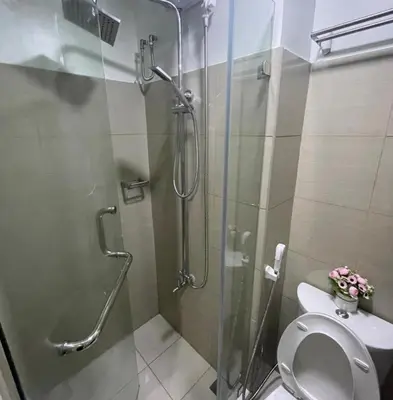 a bathroom with a glass shower and a toilet at MOA Staycation at Shore 2 in Manila