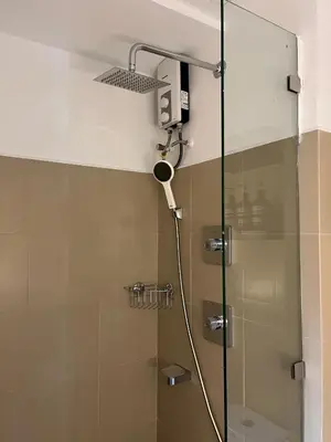 a shower with a shower head in a bathroom at New Luxury Condo in Mall of Asia and near Manila Airport in Manila