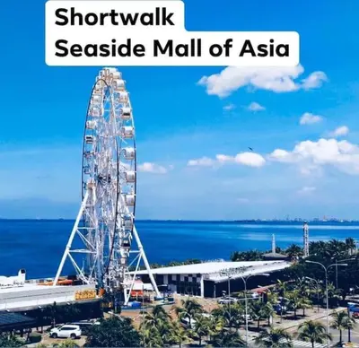 a large ferris wheel in a seaside mall of asahi at Shore Residence D22 shortwalk MOA Balconypoolview in Manila