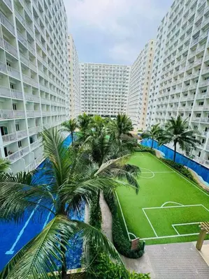 an aerial view of a resort with palm trees and buildings at Shore Residence D22 shortwalk MOA Balconypoolview in Manila