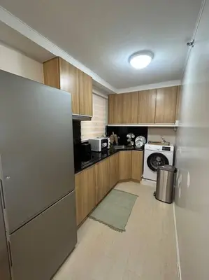a kitchen with a refrigerator and a microwave at Modern Oasis: Pool + Netflix in Manila