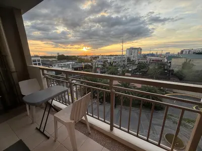 a balcony with a view of a city at Modern style 2BR Condo Good for 6 Packs Near NAIA in Manila