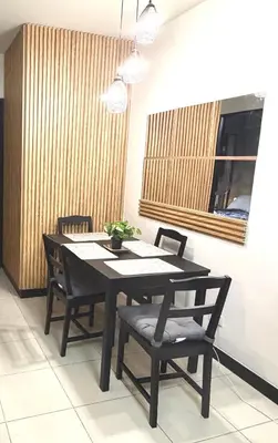 a dining room table and chairs in a room at Modern style 2BR Condo Good for 6 Packs Near NAIA in Manila