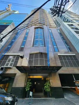 a tall building with a lot of windows at Muji KLTower Makati - Greenbelt - with Pool Access in Manila