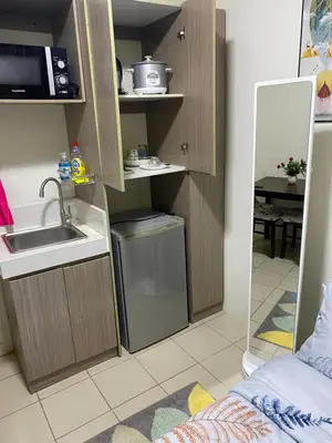a small kitchen with a sink and a microwave at Pierrecondotel in Manila