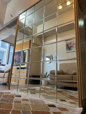 a living room with a large glass wall at Angelheaven EGPLR in Manila