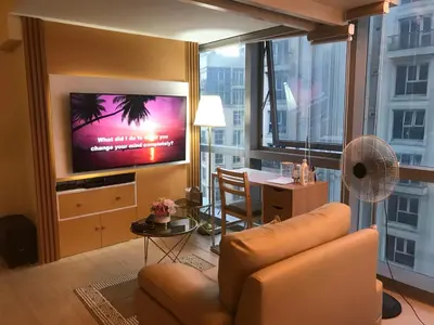 a living room with a couch and a flat screen tv at Angelheaven EGPLR in Manila