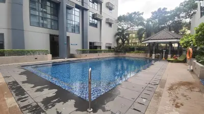 a swimming pool in front of a building at 11B Tower 1 Viceroy Residences Mc Kinley Hill BGC in Manila