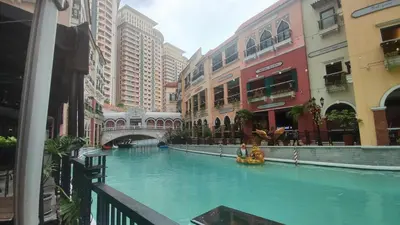 a pool in the middle of a city with buildings at 11C Tower 1 Viceroy Residences McKinley BGC in Manila
