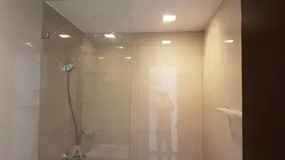 a bathroom with a shower with a glass door at 11C Tower 1 Viceroy Residences McKinley BGC in Manila