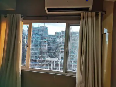 a window with a view of a large building at SHELL RESIDENCES MOA COMPLEX PASAY in Manila