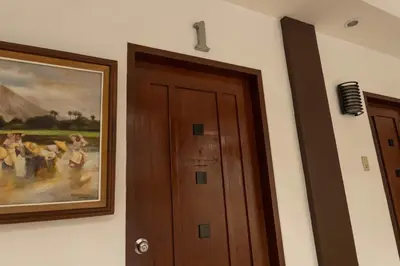 a door in a room with a painting on the wall at Teofely Gardens Resort near Tagaytay in Silang