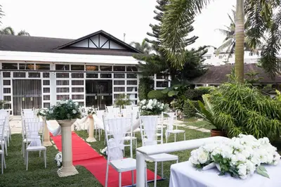 a marquee with white chairs and tables and flowers at Teofely Gardens Resort near Tagaytay in Silang