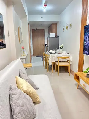 a living room with a couch and a table at Molly Shore Getaway Unit 1241 in Manila