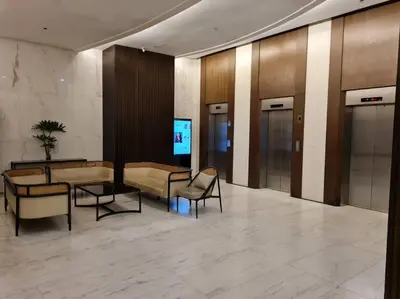 a lobby with chairs and tables in a building at Cozy 2BR in BGC near golf course - B Fort TB in Manila