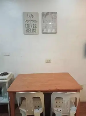 a wooden table with two chairs in a room at Matthew's Private Pool by Mia and Miguel's House in General Trias