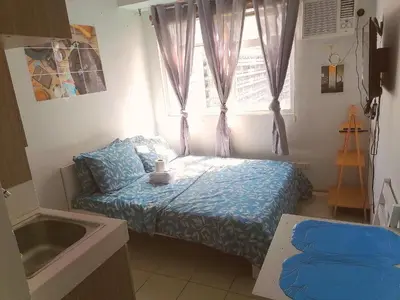 a small bedroom with a bed and a window at Para Sa'yo in Manila