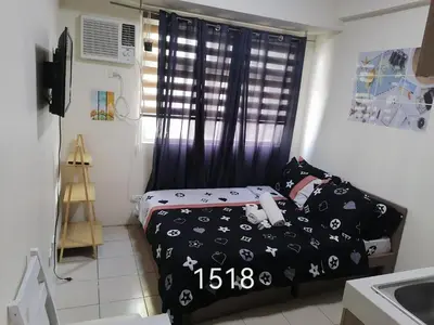 a small bedroom with a bed and a window at Para Sa'yo in Manila