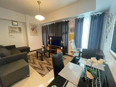 a living room with a couch and a table at 1 Bedroom Homestay in 8 Adriatico Manila in Manila