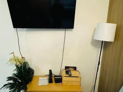 a room with a television and a table with a telephone at Shore Residence D23 shortwalk MOA in Manila