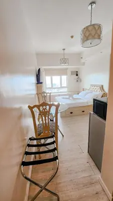 a room with a chair and a bed in it at The Beacon Condo - Studio Tower 1 in Manila