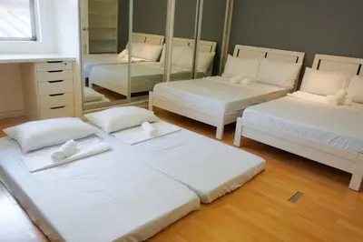 a room with two beds and a mirror at Makati Altean Apartment (Maura Room) in Manila