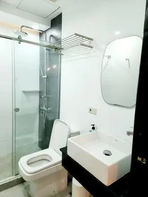 a bathroom with a sink and a toilet and a shower at Alpha Grandview Malate Condo 2005 in Manila