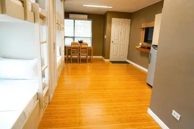 a hallway with a hard wood floor and a kitchen at ALTEAN Apartments - Isabela Room in Manila